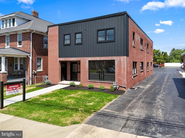 555 Carlisle St, Hanover, PA 17331 - view of front of property with board and batten siding, brick siding, and a front yard