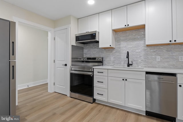 555 Carlisle St, Hanover, PA 17331 - kitchen featuring stainless steel appliances, a sink, light countertops, light wood-style flooring, and recessed lighting