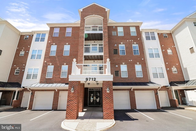 9712 Handerson Pl Unit 306, Manassas Park, VA 20111 - view of building exterior featuring an attached garage and driveway