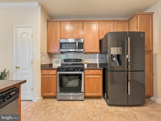 9712 Handerson Pl Unit 306, Manassas Park, VA 20111 - kitchen featuring appliances with stainless steel finishes, decorative backsplash, light tile patterned flooring, ornamental molding, and dark stone countertops
