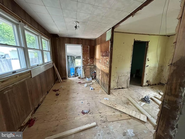 misc room featuring wooden walls