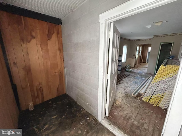 hall featuring concrete block wall