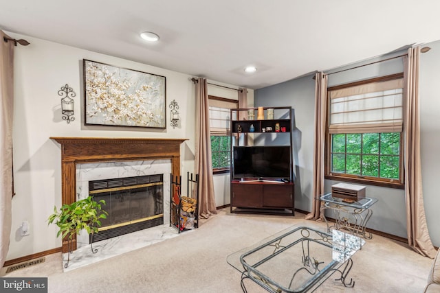 carpeted living room featuring a fireplace, baseboards, and recessed lighting