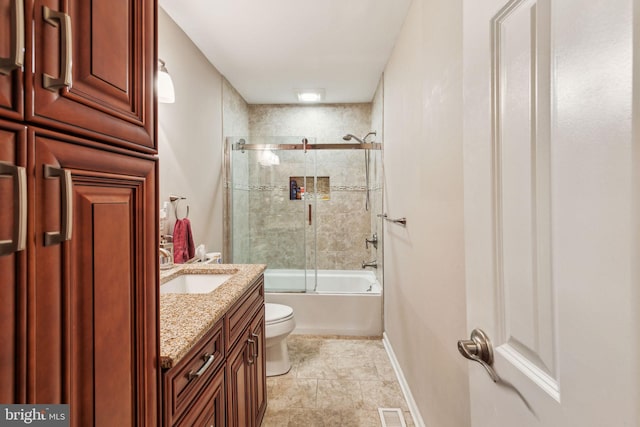 bathroom with enclosed tub / shower combo, toilet, vanity, tile patterned floors, and baseboards