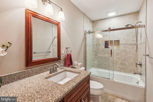 bathroom featuring enclosed tub / shower combo, toilet, and vanity