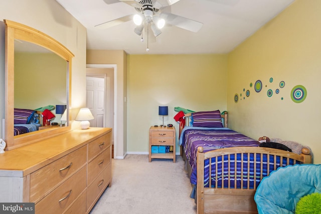 bedroom featuring light carpet, a ceiling fan, and baseboards