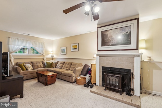 carpeted living room featuring a ceiling fan and a tile fireplace