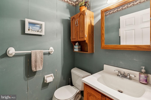bathroom featuring toilet and vanity