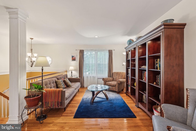 living room with light wood-style floors and a chandelier