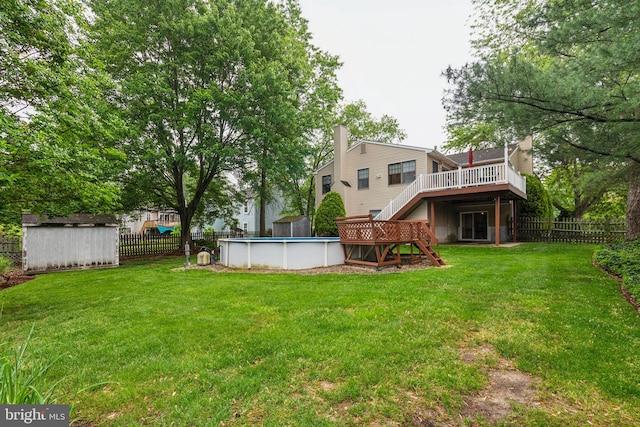view of yard featuring a deck, a storage shed, stairs, and an outdoor structure