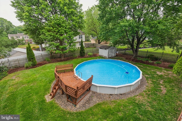view of swimming pool featuring a shed and an outbuilding