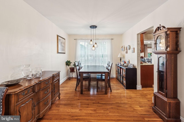dining area featuring wood finished floors and baseboards