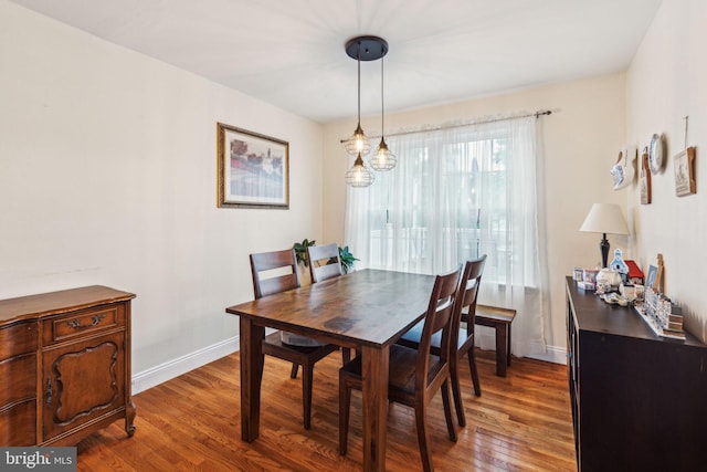 dining area featuring wood finished floors and baseboards