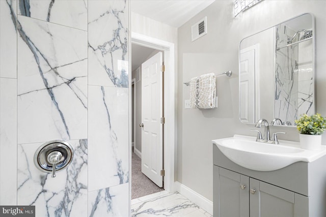 3920 Mortimer Ave, Baltimore, MD 21215 - bathroom featuring baseboards, vanity, marble finish flooring, and a shower