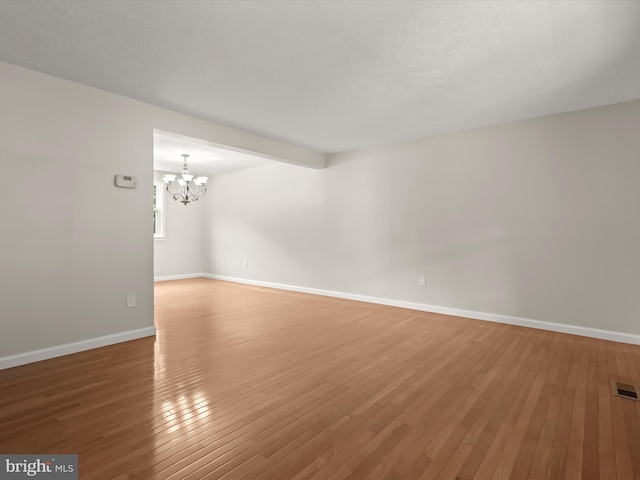 10205 Scaggsville Rd, Laurel, MD 20723 - unfurnished room with a chandelier, hardwood / wood-style flooring, and baseboards