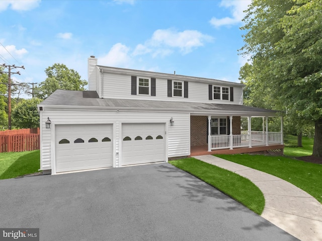 10205 Scaggsville Rd, Laurel, MD 20723 - view of front of home with covered porch, asphalt driveway, a chimney, and an attached garage