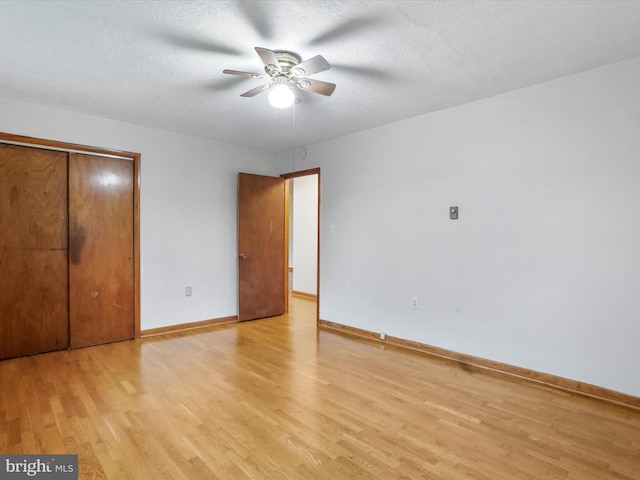 233 Molden Dr, Winchester, VA 22601 - unfurnished bedroom featuring light wood finished floors, baseboards, a closet, a textured ceiling, and a ceiling fan