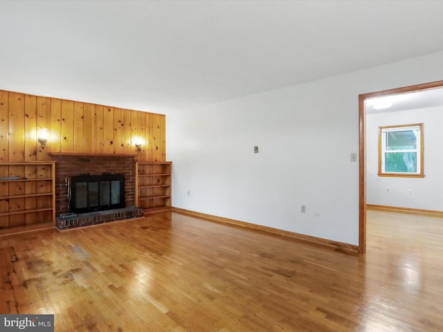 233 Molden Dr, Winchester, VA 22601 - unfurnished living room with light wood-type flooring, baseboards, and a brick fireplace