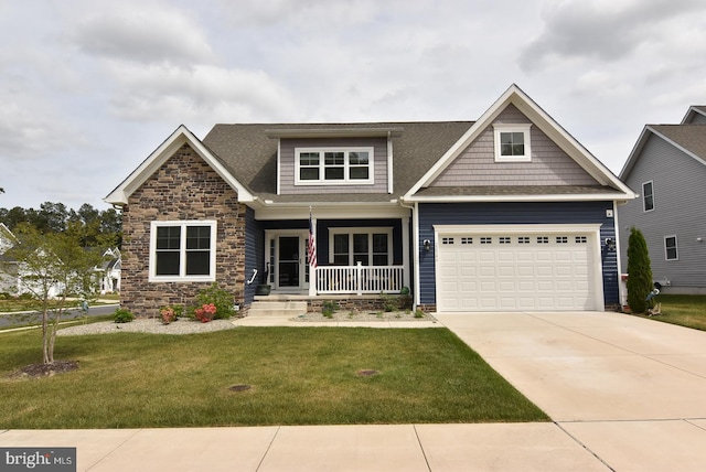 craftsman inspired home with covered porch, a front lawn, driveway, stone siding, and an attached garage