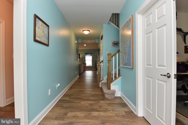hall featuring wood finished floors, stairway, and baseboards
