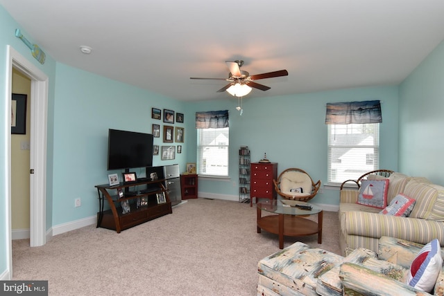 carpeted living room with ceiling fan and baseboards