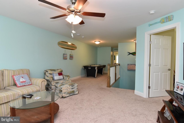 living area with carpet, ceiling fan, and baseboards