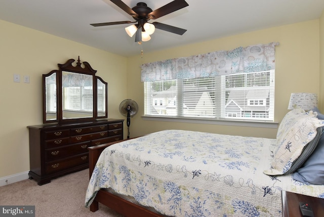 bedroom featuring carpet floors, a ceiling fan, and baseboards