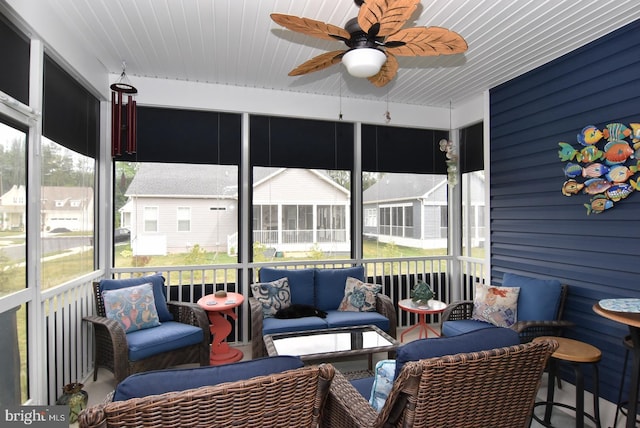 sunroom with a ceiling fan and outdoor lounge area