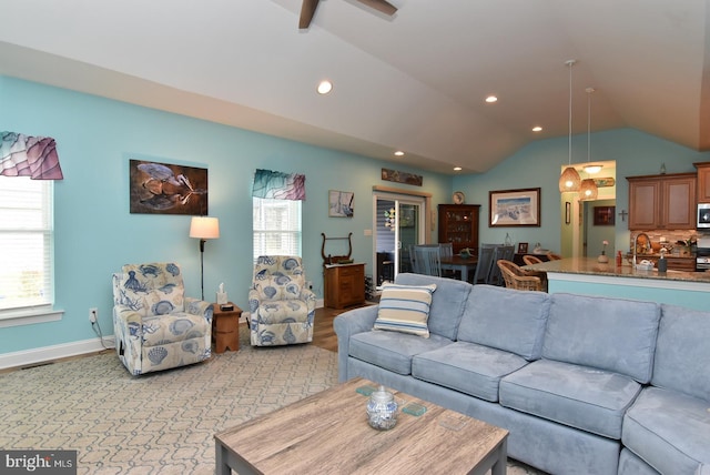 living room with vaulted ceiling, recessed lighting, light wood-type flooring, a ceiling fan, and baseboards
