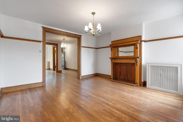 108 3rd St NE, Washington, DC 20002 - spare room with a chandelier, wood finished floors, radiator, and radiator heating unit