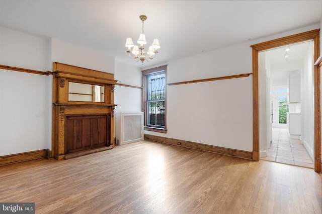 108 3rd St NE, Washington, DC 20002 - unfurnished living room with a chandelier and light wood finished floors