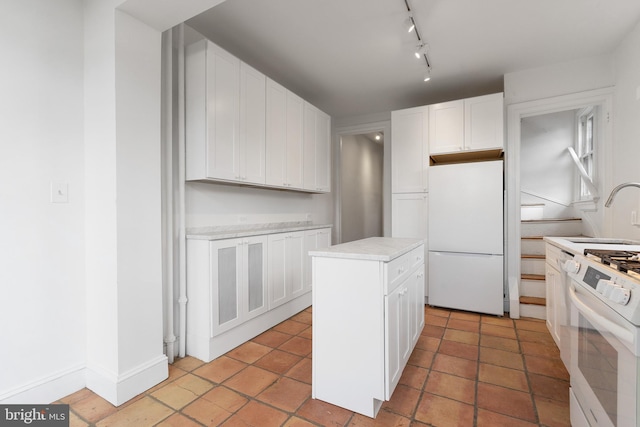 108 3rd St NE, Washington, DC 20002 - kitchen with white appliances, white cabinetry, light countertops, and a kitchen island