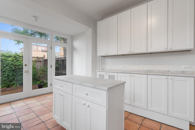 108 3rd St NE, Washington, DC 20002 - kitchen with white cabinets, light stone counters, and french doors
