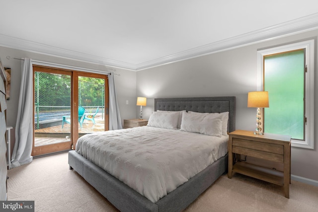bedroom with access to outside, crown molding, and carpet floors