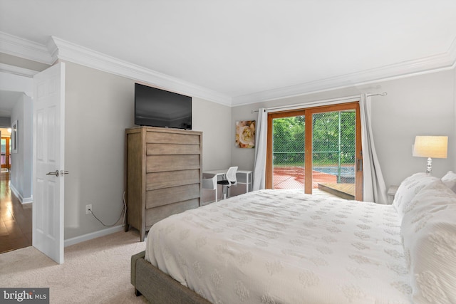 carpeted bedroom featuring access to exterior, crown molding, and baseboards
