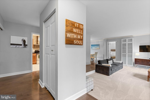 corridor featuring baseboards and dark wood finished floors