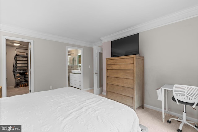 bedroom with crown molding, a walk in closet, light carpet, a closet, and baseboards
