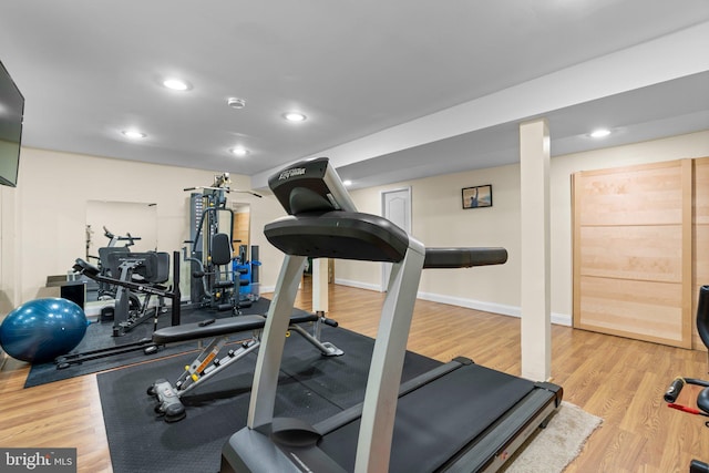 exercise room featuring wood finished floors, baseboards, and recessed lighting
