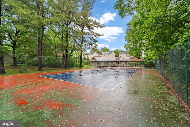 view of tennis court featuring fence