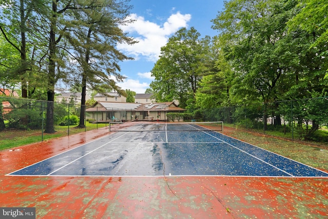 view of tennis court with fence