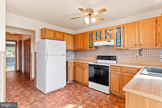 kitchen featuring freestanding refrigerator, electric range, under cabinet range hood, light countertops, and decorative backsplash