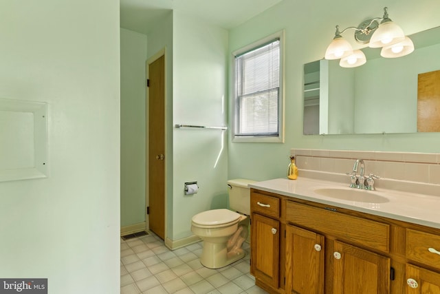 bathroom with toilet and vanity