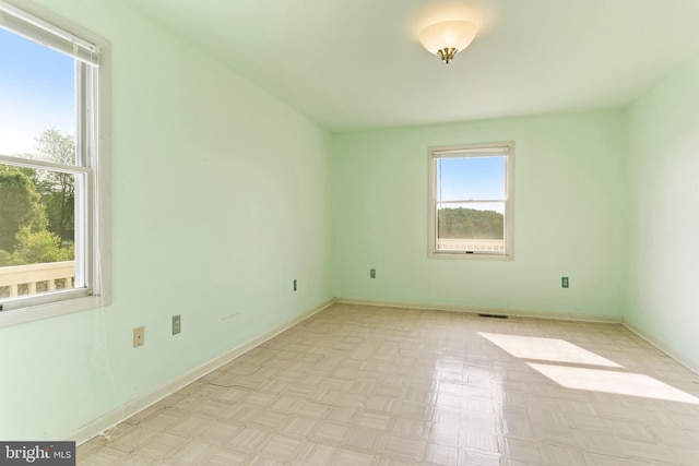 spare room featuring baseboards