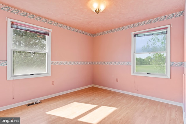 unfurnished room featuring wood finished floors and baseboards