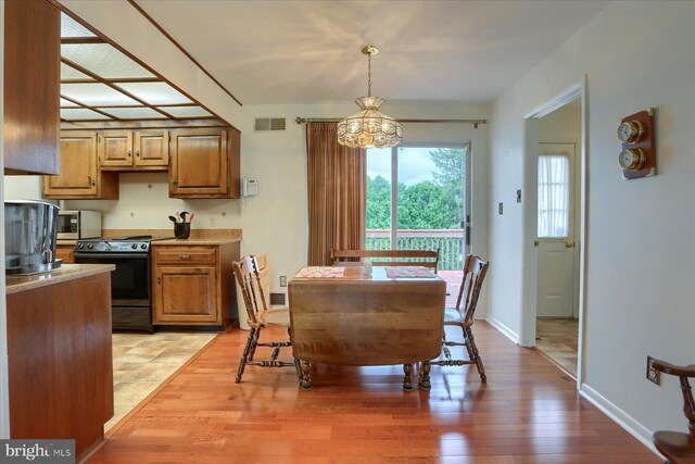 438 N 4th St, Halifax, PA 17032 - dining space featuring a chandelier, light wood-style flooring, and baseboards