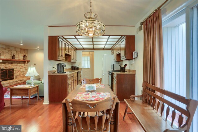 438 N 4th St, Halifax, PA 17032 - dining room with a chandelier, light wood-style floors, and a stone fireplace