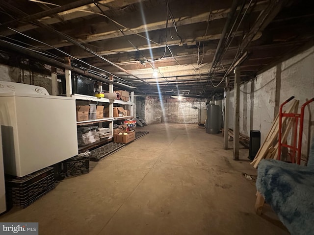unfinished basement featuring washer / dryer and gas water heater