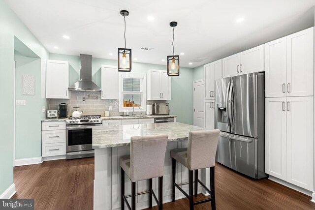 401 Woodland Ave, Glendora, NJ 08029 - kitchen featuring appliances with stainless steel finishes, wall chimney exhaust hood, dark wood-style floors, a sink, and recessed lighting