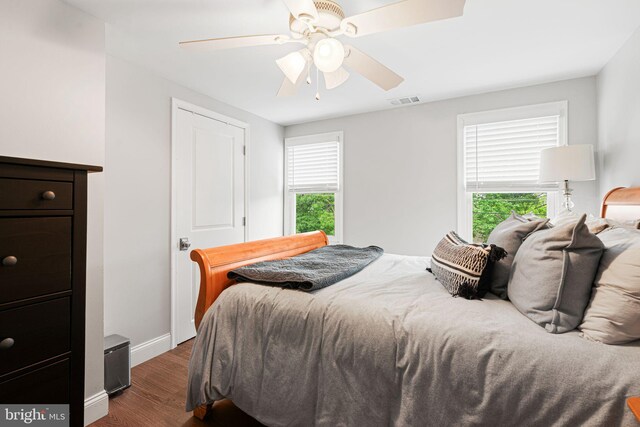 401 Woodland Ave, Glendora, NJ 08029 - bedroom with dark wood finished floors, multiple windows, baseboards, and a ceiling fan