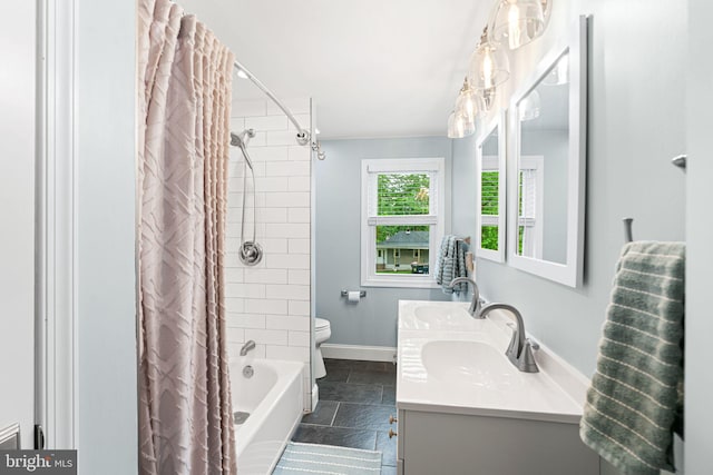 401 Woodland Ave, Glendora, NJ 08029 - bathroom featuring stone tile floors, shower / bath combo, toilet, double vanity, and baseboards